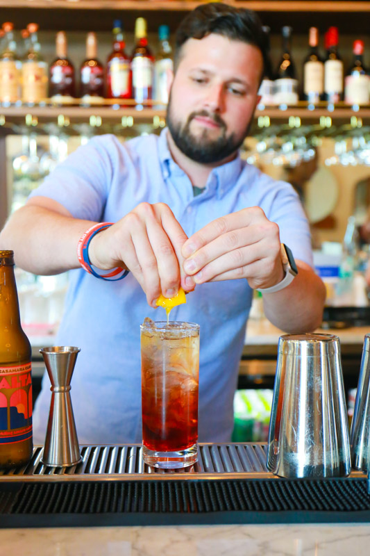 Jame creates a Negroni Americano at Red Rooster. 